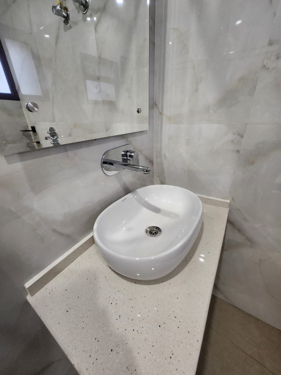 A white vessel basin on a stone vanity in an Executive Room bathroom