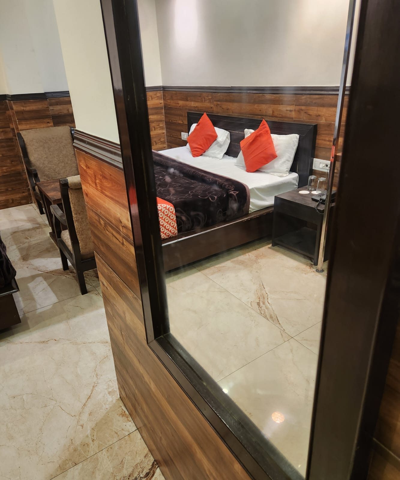 An Executive Room seen through its full-length walnut-framed mirror