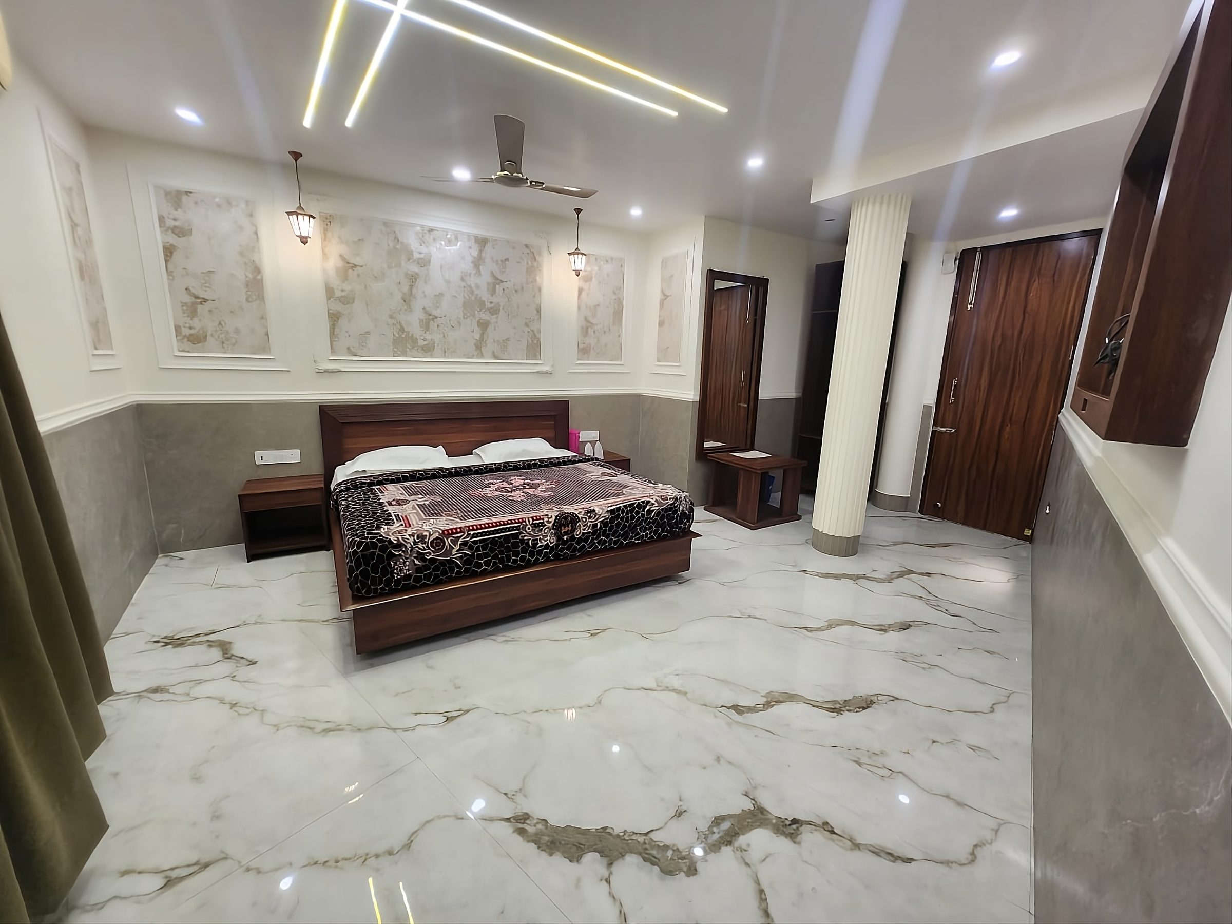 Executive Room — a double bed on a polished marble floor under strip lighting